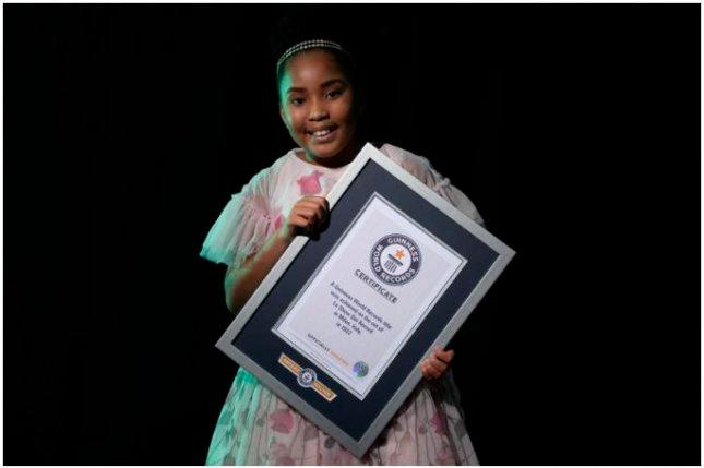Victory Brinker posing with her Guinness World Record. — GUINNESS WORLD RECORD