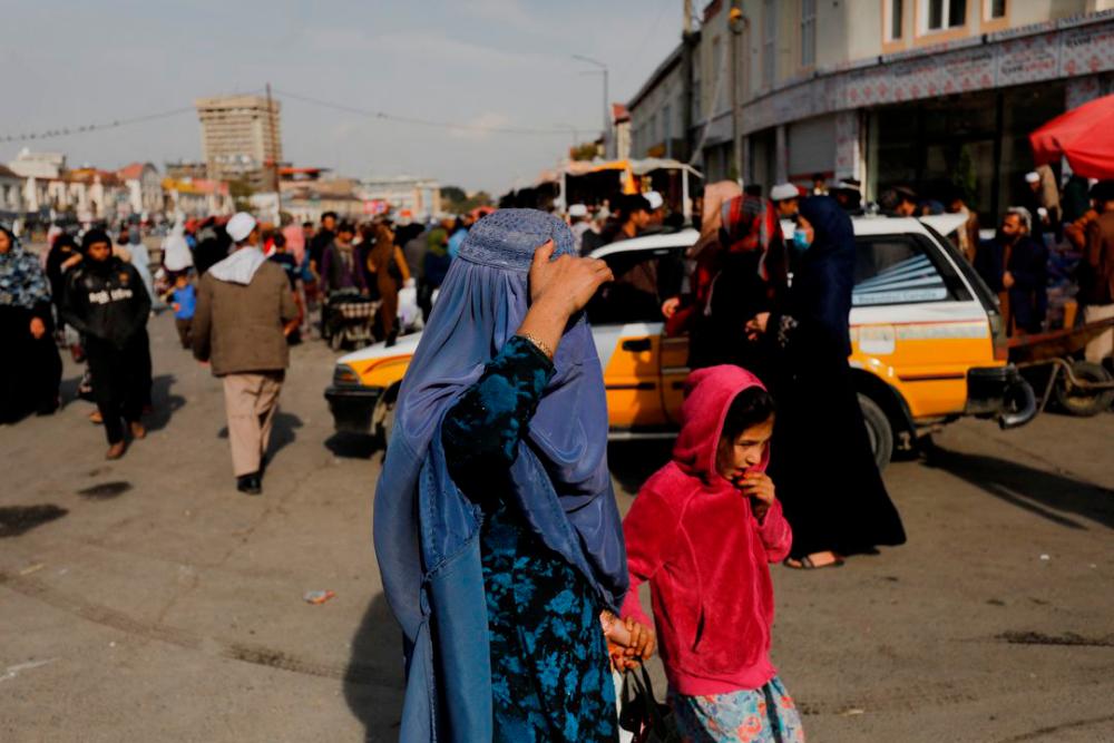 An Afghan woman and a girl walk in a street in Kabul, Afghanistan, November 9, 2022. REUTERSpix