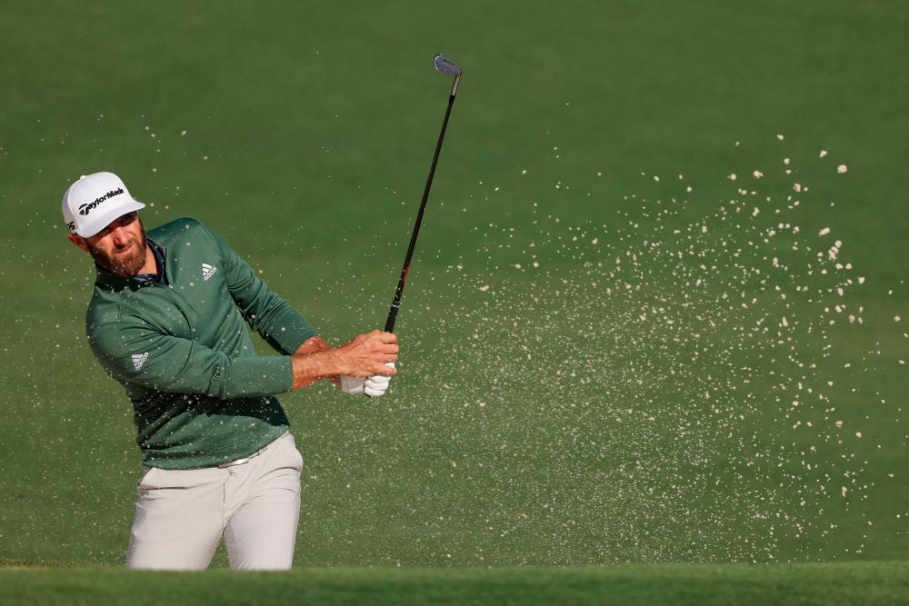 Johnson plays a shot from a bunker on the 2nd hole during a practice round prior to the Augusta Masters. – AFPPIX