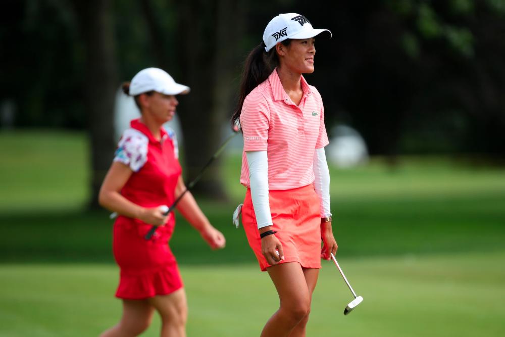 Teammates Karine Icher (L) and Celine Boutier of France walk off the 17th green during round two of the Dow Great Lakes Bay Invitational at Midland Country Club on July 18, 2019 in Midland, Michigan. — AFP