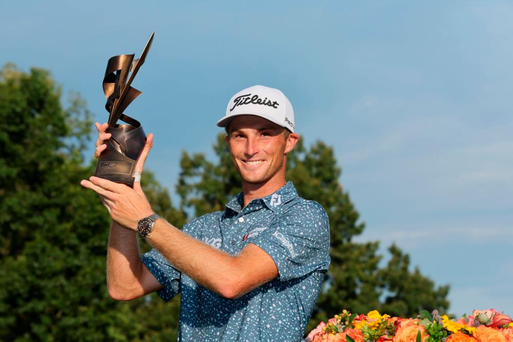 MEMPHIS, TENNESSEE - AUGUST 14: Will Zalatoris of the United States poses with the trophy after putting in to win on the third playoff hole on the 11th green during the final round of the FedEx St. Jude Championship at TPC Southwind on August 14, 2022 in Memphis, Tennessee. AFPPIX