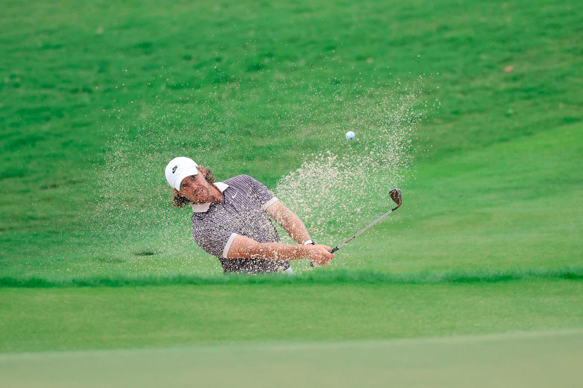 Tommy Fleetwood of England plays a shot from a bunker on the 18th hole during the third round of the TOUR Championship 2025 at East Lake Golf Club in Atlanta, Georgia. - Getty Images/AFP