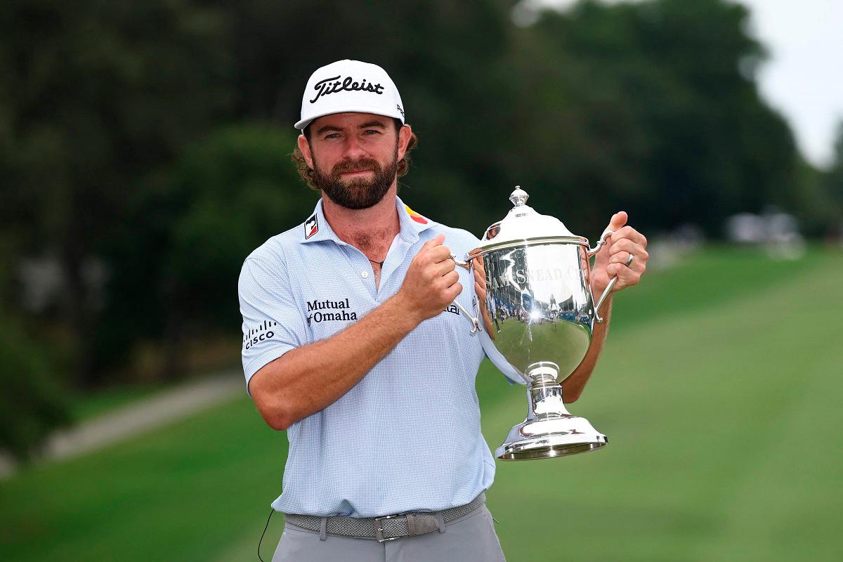 Cameron Young of the United States poses with the Wyndham Championship trophy on the 18th green after the final round of the Wyndham Championship 2025 at Sedgefield Country Club on August 03, 2025 in Greensboro, North Carolina. - Jared C. Tilton/Getty Images/AFP