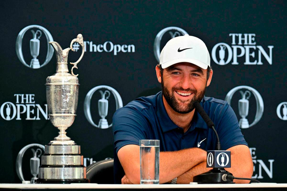 US golfer Scottie Scheffler with the Claret Jug, the trophy for the Champion golfer of the year beside him, holds a press conference after his victory in the 153rd Open Championship at Royal Portrush golf club in Northern Ireland on July 20, 2025 - AFP