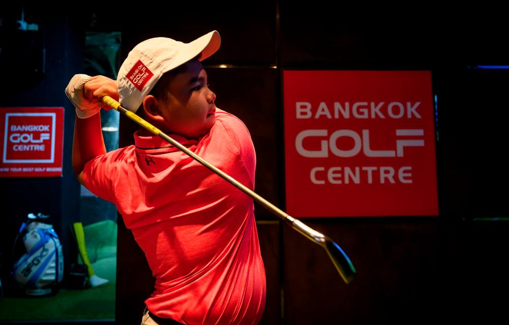 This picture taken on Aug 16, 2019, shows Poomrapee Top Gun Kaewpiboon practising his swing at the Bangkok Golf Centre in Bangkok. — AFP