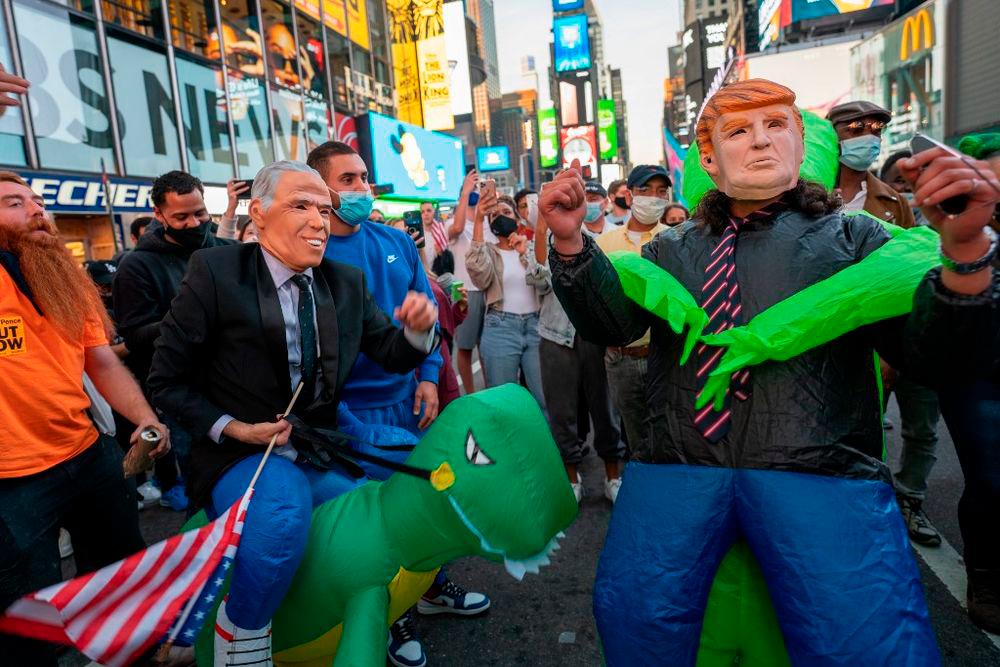 People celebrate in the streets in Times Square on November 7, 2020 in New York City. — Getty Images via AFP