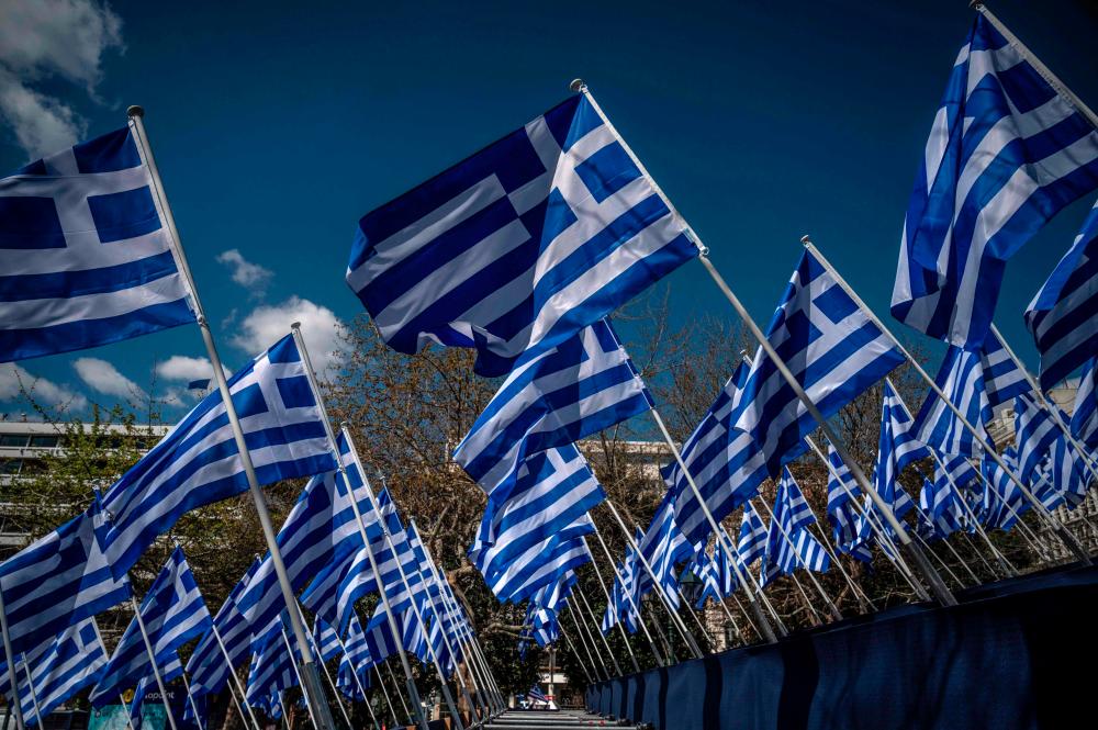 Greek flags displayed on the Syntagma square in Athens, on March 24, 2021. - AFP