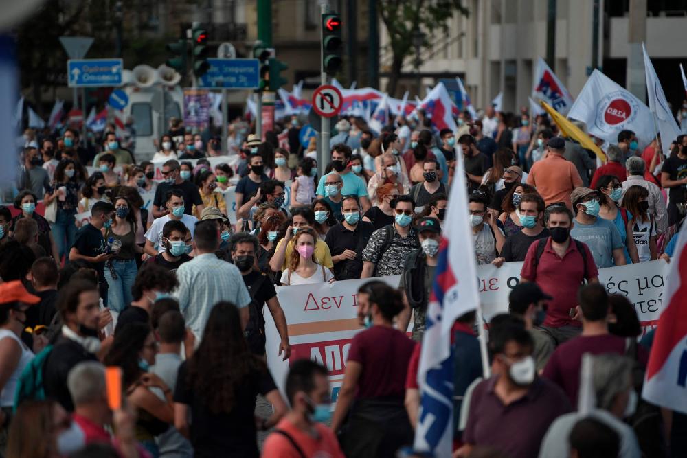 Protesters gather in front of the Greek parliament in Athens on June 16, 2021, to protest against a labour bill being voted in the parliament. – AFP