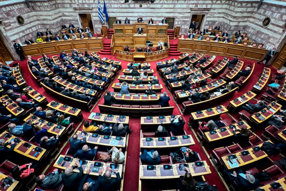 Greek Prime Minister Kyriakos Mitsotakis (C) delivers a speech during a parliamentary debate on a vote of no confidence against the government in Athens on January 27, 2023. AFPPIX