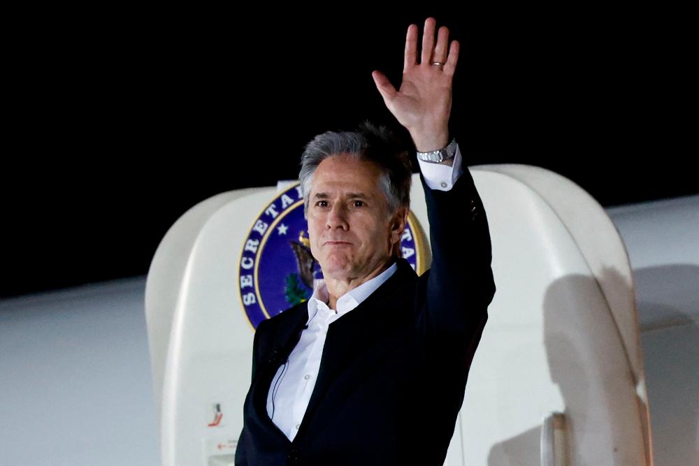 US Secretary of State Antony Blinken waves as he boards a plane leaving Crete for Amman, on January 6, 2024, as part of the first leg of a trip that includes visits to both Israel and West Bank/AFPPix