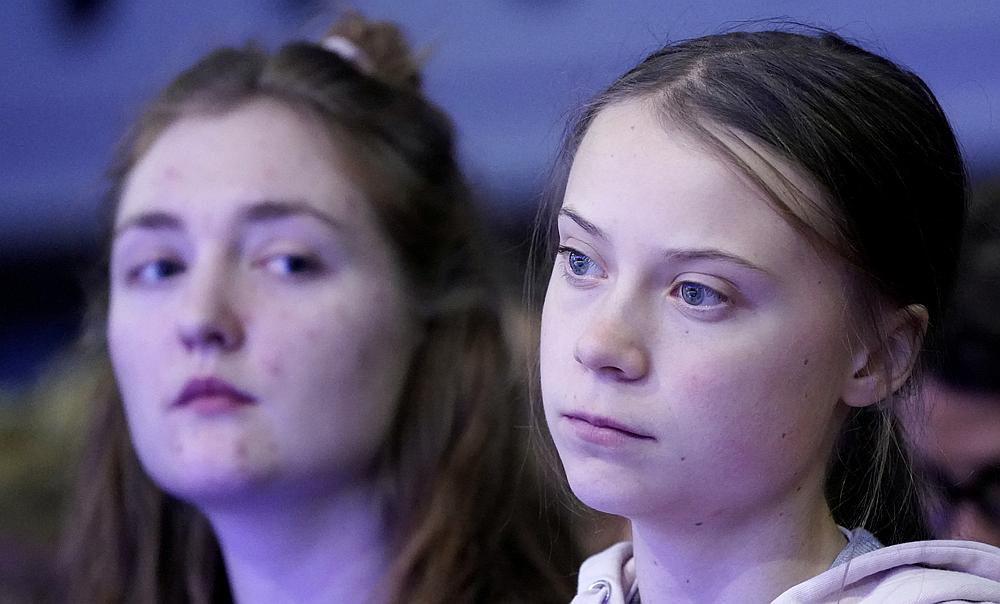 Swedish climate change activist Greta Thunberg and Swiss activist Loukina Tille attend a session at the 50th World Economic Forum (WEF) annual meeting in Davos, Switzerland, January 21. — Reuters