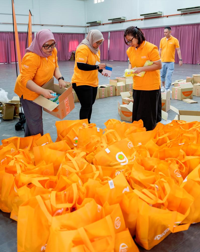 $!Guardian Malaysia volunteers packing the flood aid items for distribution by MRC.