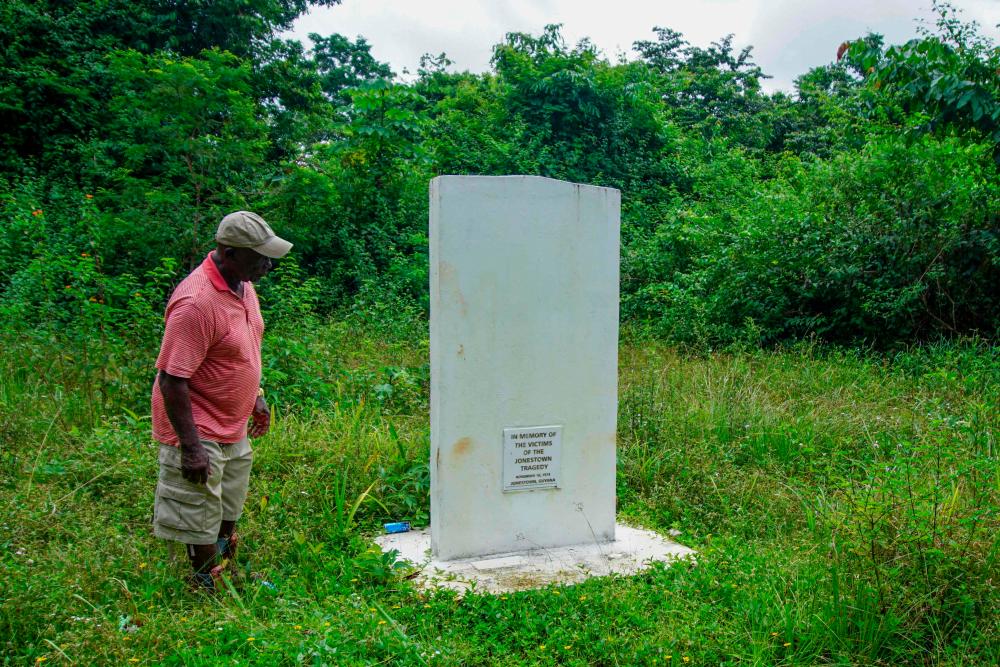 Fitz Duke looks at the memorial site for the victims of the Jonestown Massacre (1978) in Jonestown, Guyana, on September 21, 2022. Deep in the Guyanese jungle, only a signpost and a nondescript plaque serve as memories of a cult settlement where one of the most spine-chilling mass murder-suicides in modern history took place almost five decades ago. AFPPIX