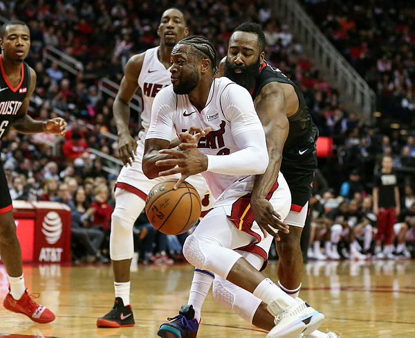 Houston Rockets guard James Harden (13) knocks the ball away from Miami Heat guard Dwyane Wade (3) during the fourth quarter at Toyota Center. — AFP