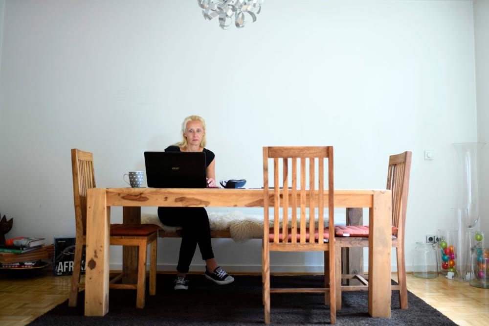 Catering manager Lulu Pototschnik works in her apartment in Essen, western Germany on July 29, 2020. — AFP