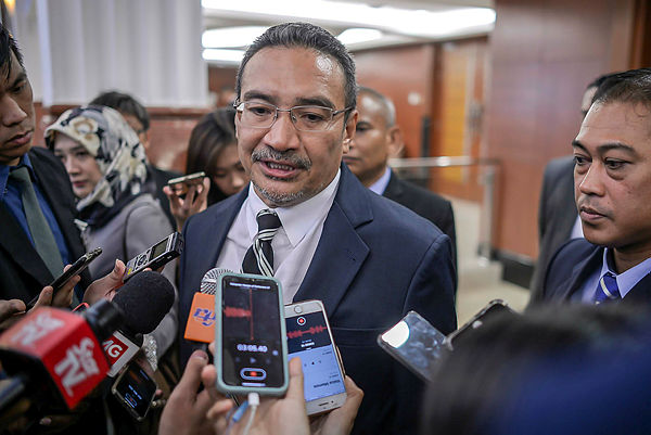 Former defence minister Datuk Seri Hishamuddin Hussein speaks with the media during the Dewan Rakyat sitting on March 12, 2019. — Sunpix by Adib Rawi Yahya