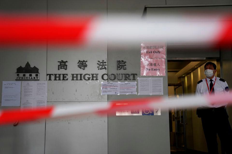 A guard stands behind cordons before a court hearing on the appeal against the bail release of 11 pro-democracy activists charged with national security violations, at the High Court in Hong Kong, China March 11, 2021. REUTERSPIX