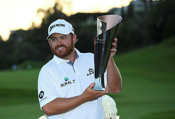 J.B. Holmes poses with the trophy after winning the Genesis Open at Riviera Country Club — AFP