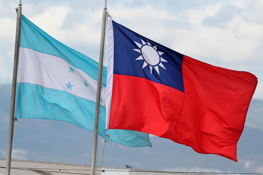 Honduras and Taiwan national flags fly at a square in Tegucigalpa on March 23, 2023. AFPPIX