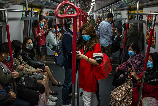 People wear masks on a train on the first day of the Lunar New Year of the Rat in Hong Kong on Jan 25. — AFP