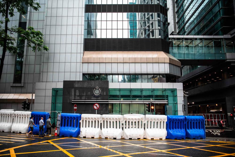 Water barriers stand outside the Hong Kong Police Headquarters in the city's Wan Chai district on July 20, 2019, ahead of an expected anti-government rally on July 21. - AFP