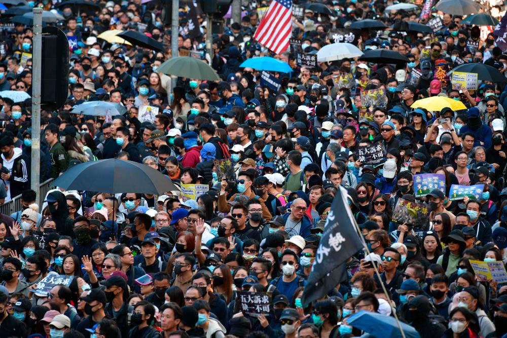 People take part in a pro-democracy rally from Victoria Park to Chater Road in Hong Kong on December 8, 2019. - AFP