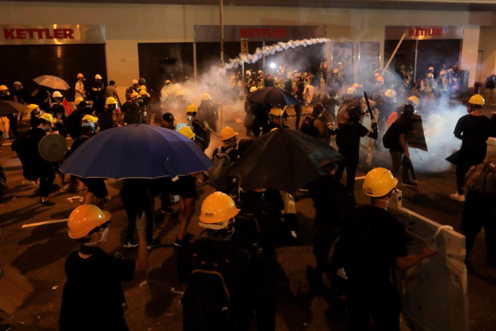 Police tear gas at protesters to disperse them after a march against a controversial extradition bill in Hong Kong on July 21, 2019. — AFP