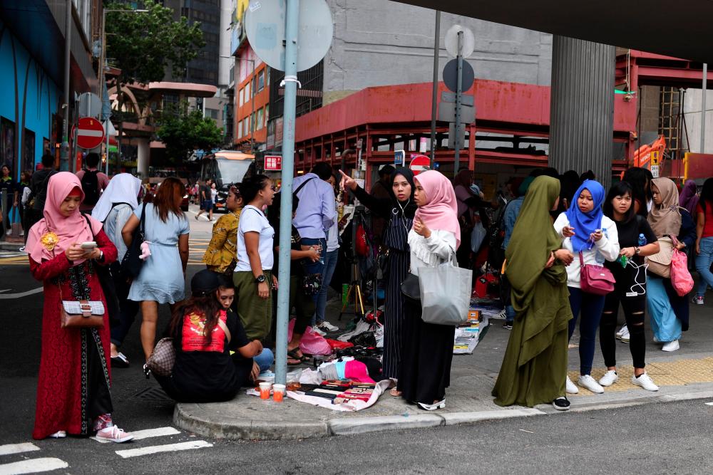 This picture taken on Oct 13, 2019 shows Indonesian migrant workers gathering near Victoria Park in Hong Kong. — AFP