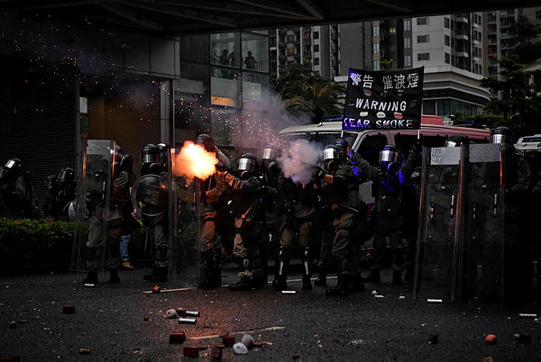 Police fire tear gas in Tseun Wan in Hong Kong on Aug 25, 2019 in the latest opposition to a planned extradition law that has since morphed into a wider call for democratic rights in the semi-autonomous city. — AFP