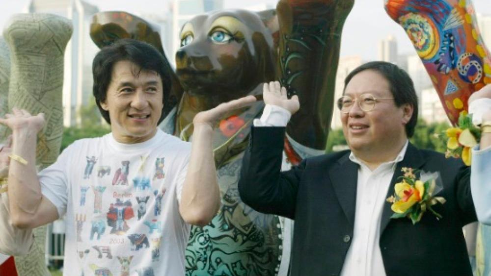 Former Hong Kong home affairs secretary Patrick Ho Chi Ping (R), pictured in a 2003 photograph with movie star Jackie Chan, has been convicted over a bribery scheme. — AFP