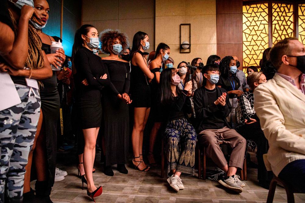 $!This picture taken on November 6, 2020 shows models and guests watching the ‘Harmony IV’ fashion show in Hong Kong, which aims to celebrate the city’s diversity. - AFP / Anthony WALLACE