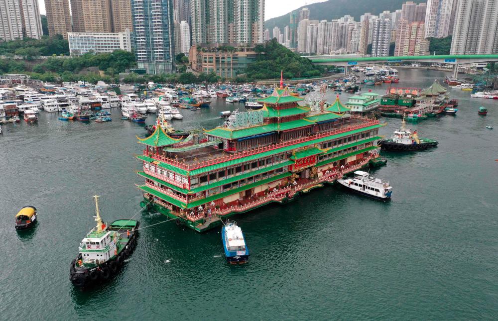 This file photo taken on June 14, 2022 shows an aerial view of Hong Kong's Jumbo Floating Restaurant, an iconic but aging tourist attraction designed like a Chinese imperial palace, being towed out of Aberdeen Harbour. AFPpix