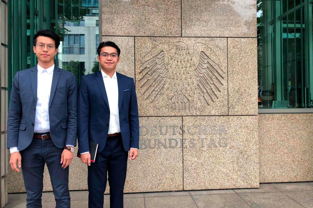 This handout courtesy of Ray Wong taken in June 2018 and released on May 22, 2019 shows activists Ray Wong (L) and Alan Li posing for a photo in Berlin. — AFP