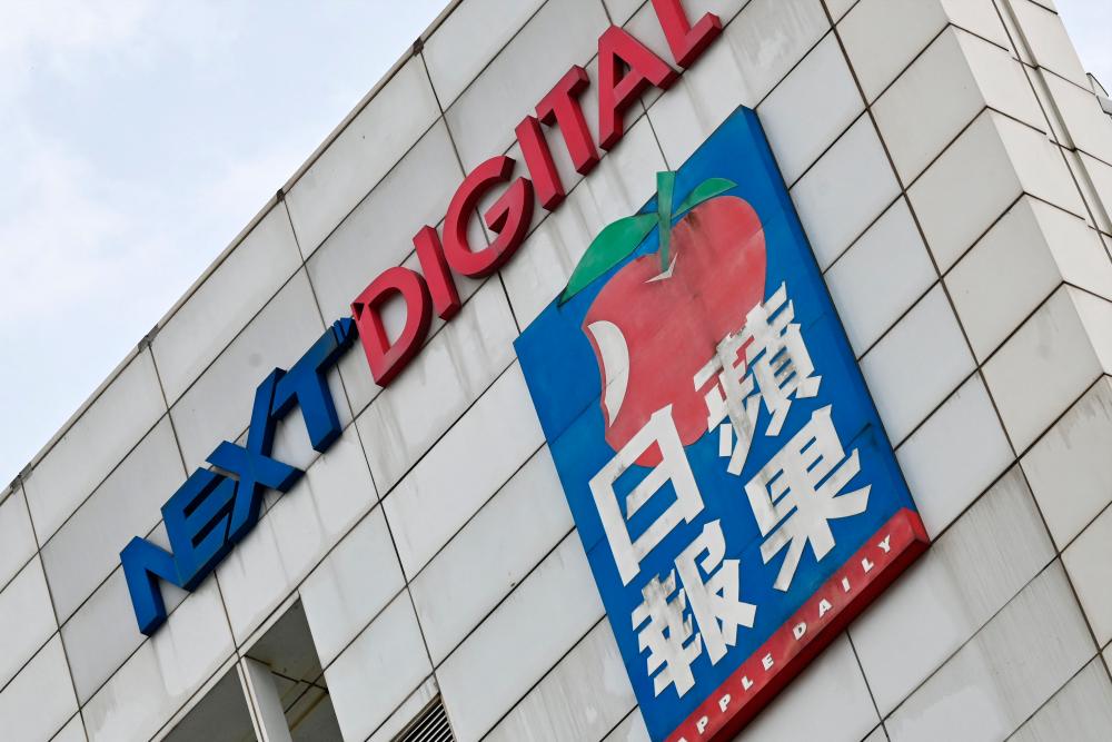 The logo of Next Media and Apple Daily are seen on their headquarters in Hong Kong on June 22, 2021. – AFP