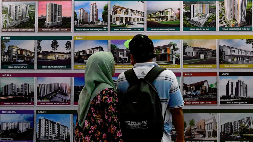 Visitors looking at affordable houses for sale at a housing expo. – BERNAMAPIX