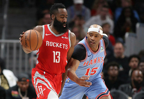 Houston Rockets guard James Harden (13) is fouled by Atlanta Hawks forward Vince Carter (15) in the second half at State Farm Arena — Reuters
