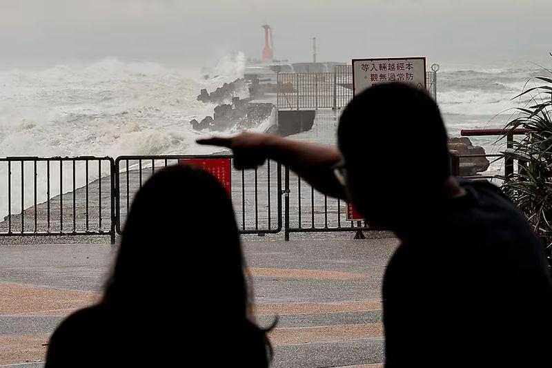 Tourists watch the waves as Typhoon Krathon approaches, in Kaohsiung - REUTERSpix