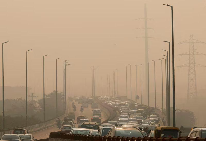 Vehicles drive on a highway on a polluted smoggy morning in New Delhi - REUTERSpix