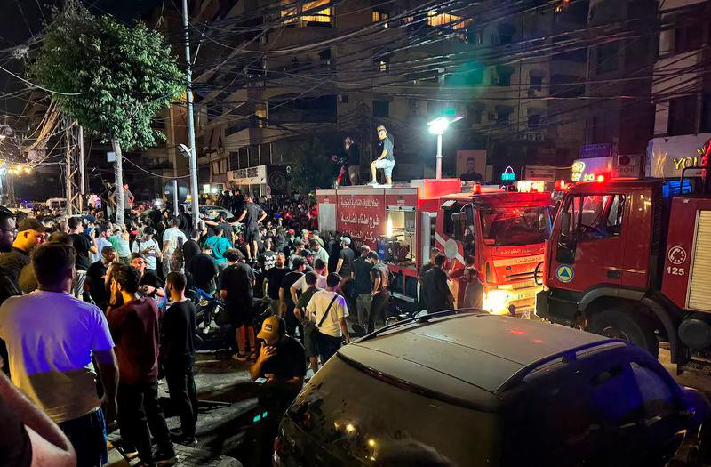 People gather near a site hit by what security sources said was a strike on Beirut’s southern suburbs, Lebanon - REUTERSpix