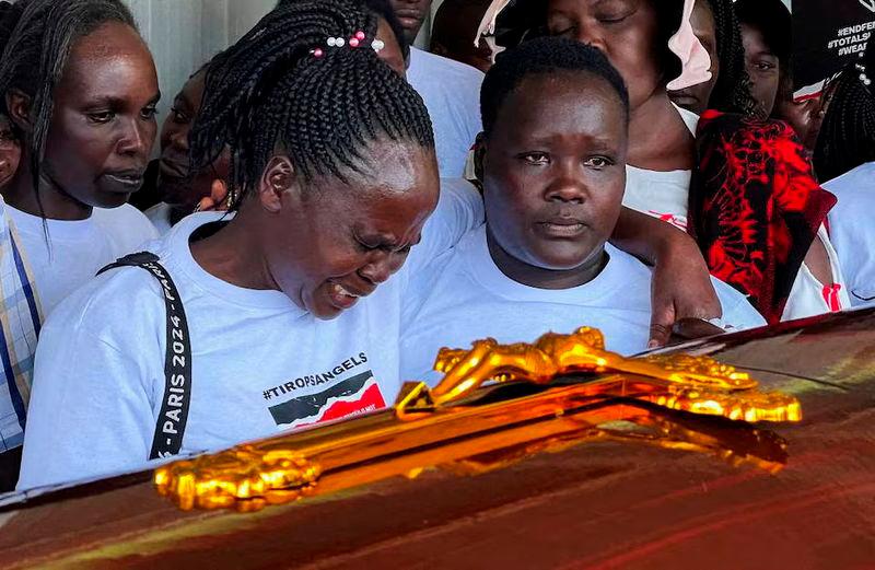 Agnes Cheptegei mourns next to the coffin of her daughter and Olympian Rebecca Cheptegei, who died after her former boyfriend doused her in petrol and set her ablaze, at the Moi Teaching &amp; Referral Hospital (MTRH) funeral home, in Eldoret - REUTERSpix