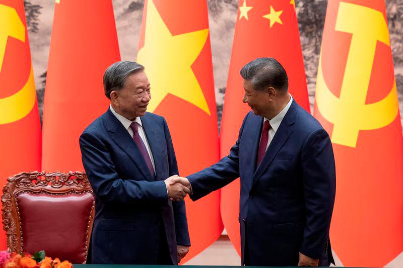 Chinese President Xi Jinping and Vietnam’s President To Lam shake hands after a signing ceremony at the Great Hall of the People in Beijing - REUTERSpix