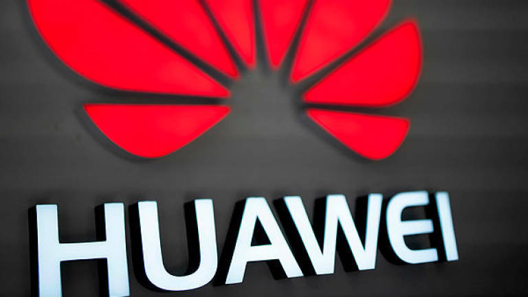 The Huawei logo is displayed at a store in Beijing — AFP