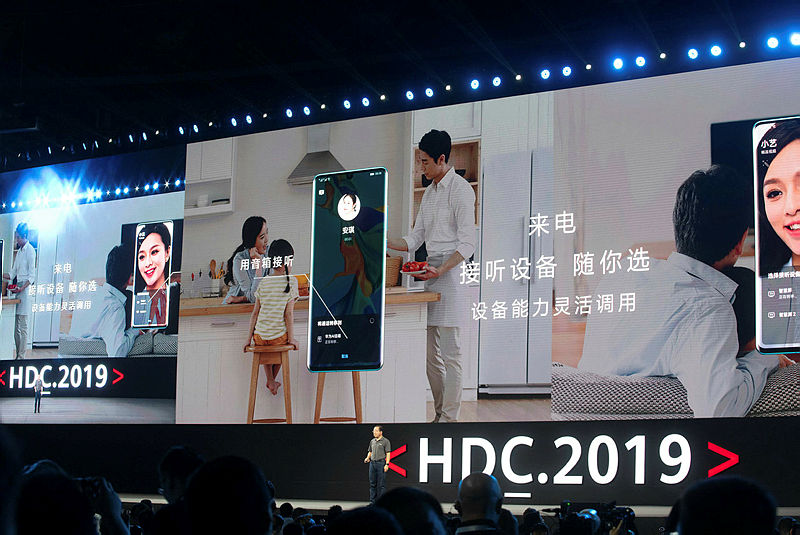 Richard Yu (bottom C), head of Huawei’s consumer business, is seen in front of a giant screen as he unveils the company’s new HarmonyOS operating system during a press conference in Dongguan, Guangdong province on Aug 9, 2019. — AFP