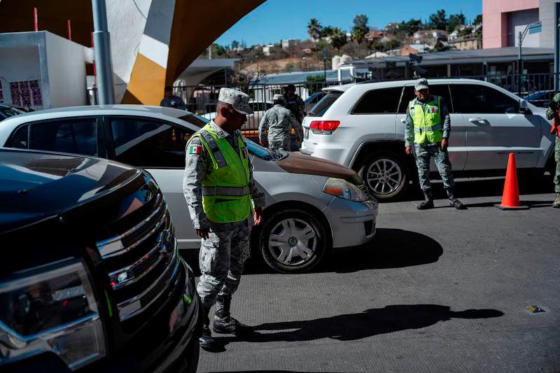 Mexican National Guard members inspect vehicles waiting in line to cross into the United States from Mexico through the Dennis DeConcini Port of Entry in Nogales, Sonora, Mexico - REUTERSpix