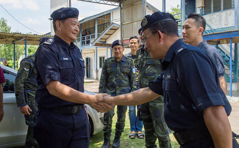 Inspector-General of Police Datuk Seri Abdul Hamid Bador (L) is greeted by officers from General Operations Force Ninth Battalion (GOF9), during a visit to the Kelantan side of the Malaysia-Thailand border, on May 22, 2019. — Bernama