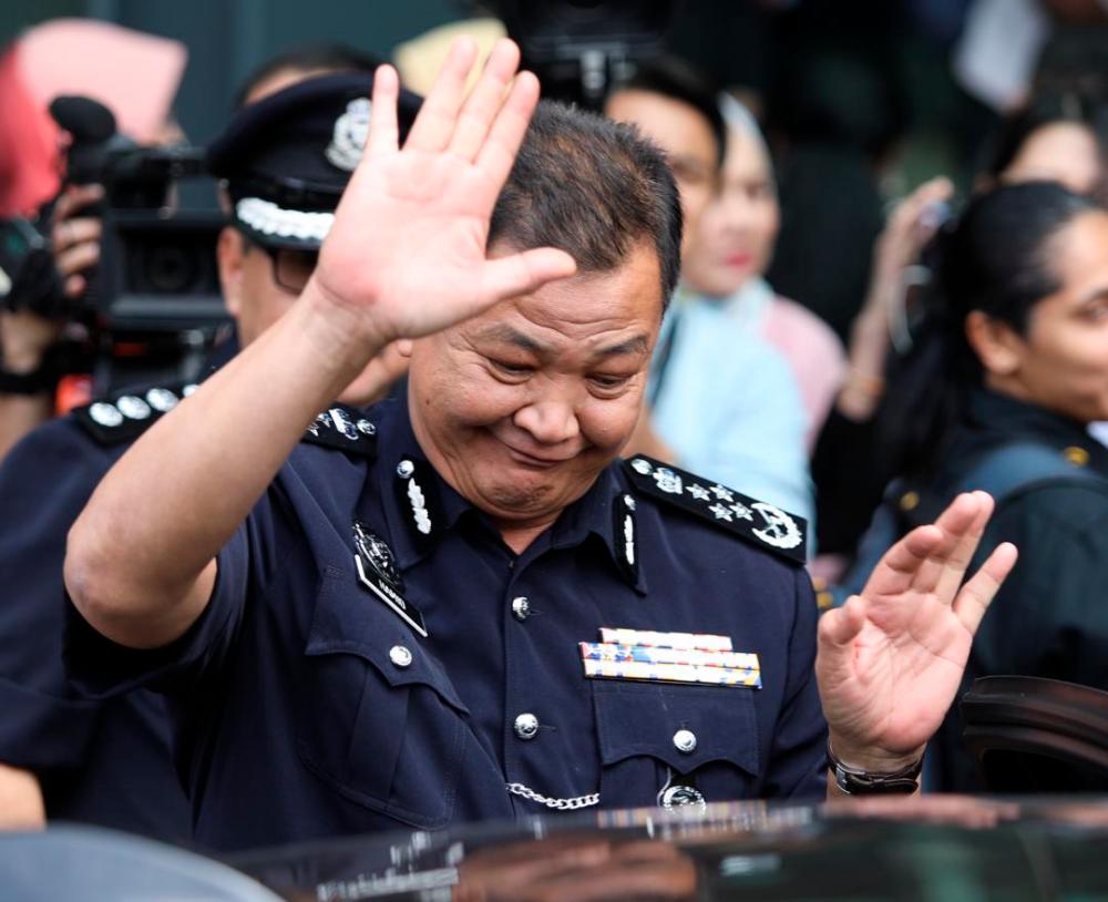 Inspector-General of Police (IGP), Datuk Seri Abdul Hamid Bador waves to the media after attending the National Strategy for Financial Literacy 2019-2023, on July 23, 2019. — Sunpix by Norman Hiu