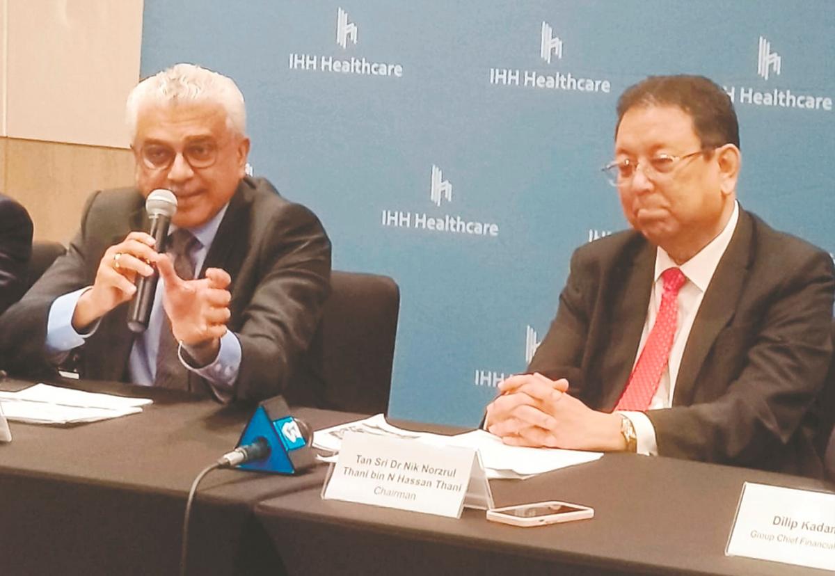 Dr Prem (left) with IHH Healthcare chairman Tan Sri Dr Nik Norzrul Thani N Hassan Thani at a press conference after the company’s annual general meeting yesterday.