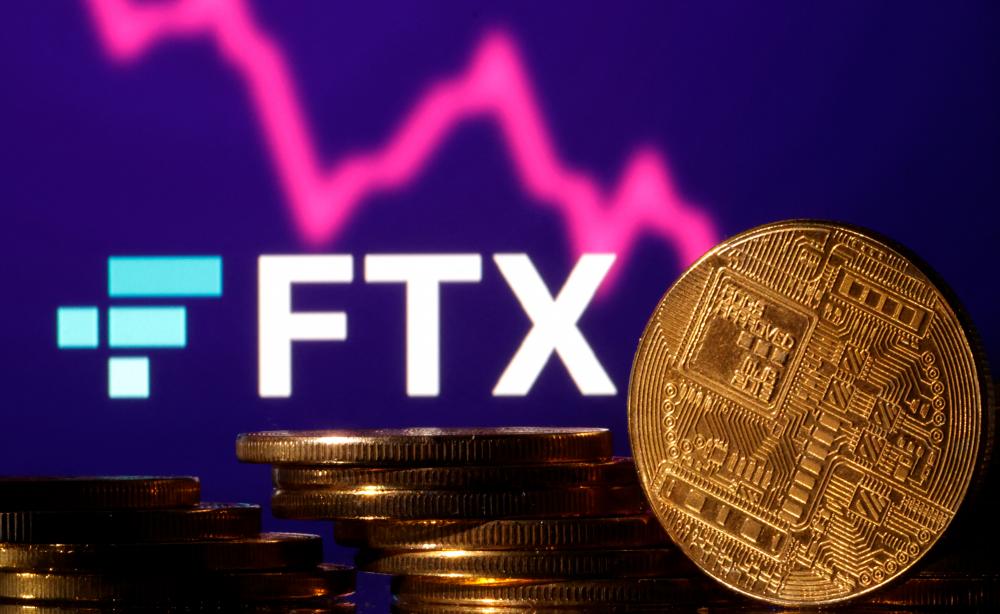 Representations of cryptocurrencies are seen in front of displayed FTX logo and graph in this illustration. – Reuterspic