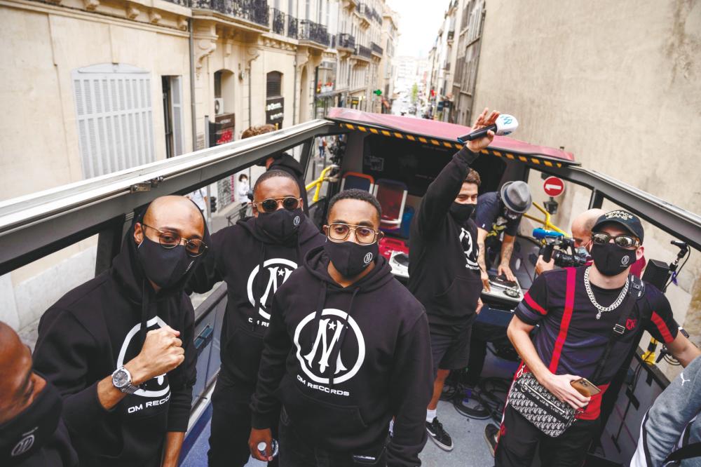 Rap artists from Marseille on a bus during the launch of new rap-based record label OM Records.