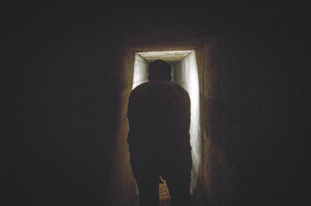 A visitor entering a dark tunnel at the Penang War Museum. – Bernama